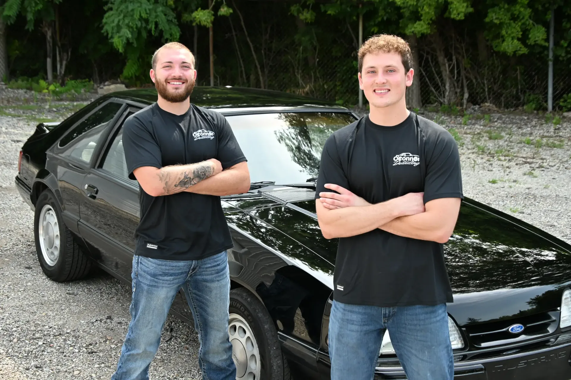 Mustang in the shop with O'Connor Detailing banner