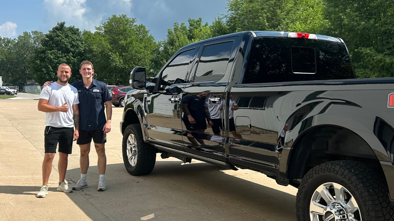 Chris and Grayson of O'Connor Detailing with a customer F-250